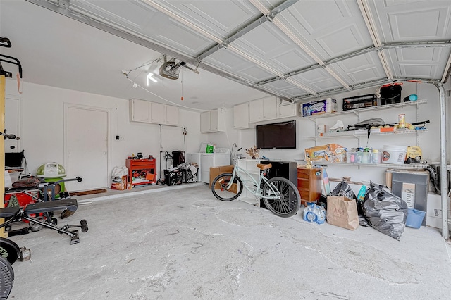 garage with a garage door opener and washer / clothes dryer