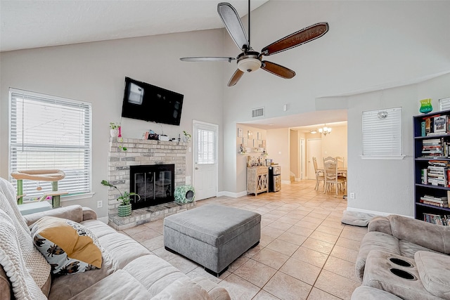 living room with plenty of natural light, lofted ceiling, and a brick fireplace