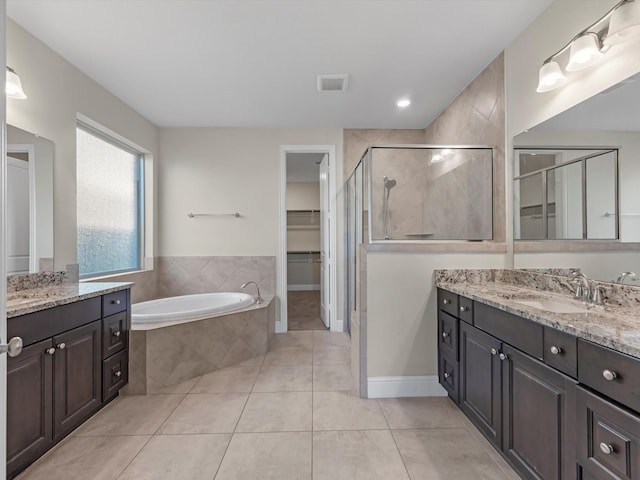 bathroom with tile patterned floors, vanity, and separate shower and tub