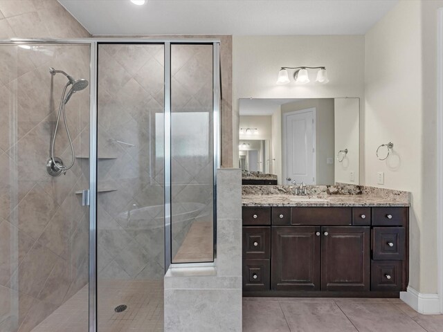 bathroom featuring tile patterned flooring, vanity, and an enclosed shower