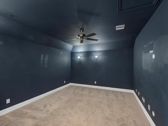 carpeted empty room with vaulted ceiling and ceiling fan