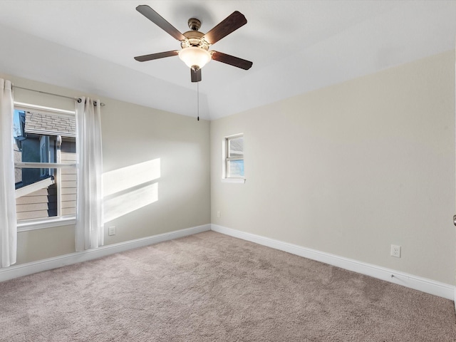 carpeted empty room with ceiling fan and vaulted ceiling