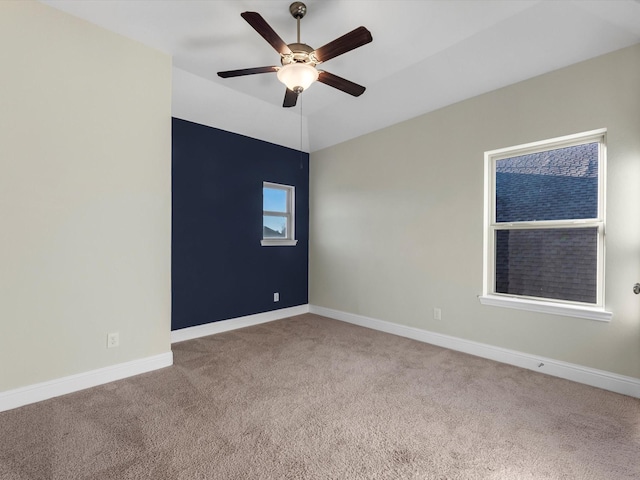 carpeted empty room featuring ceiling fan