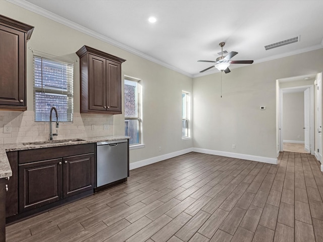 kitchen with ceiling fan, sink, stainless steel dishwasher, crown molding, and dark brown cabinets