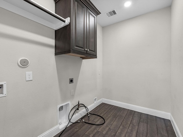 laundry area featuring cabinets, hookup for a washing machine, gas dryer hookup, and electric dryer hookup