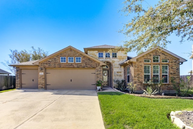 view of front of house featuring a front yard and a garage