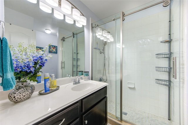 bathroom with a shower with door and vanity