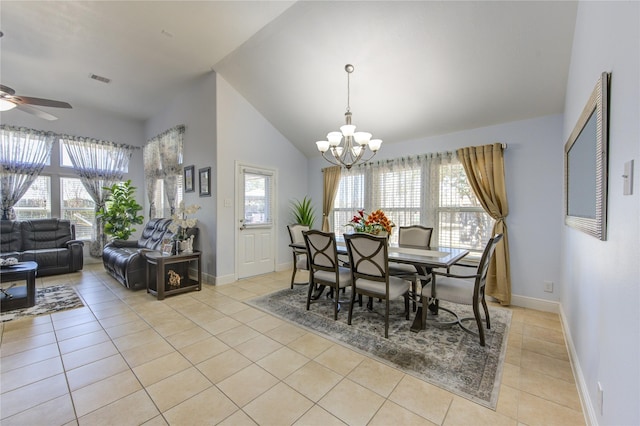 dining room with light tile patterned floors, ceiling fan with notable chandelier, and high vaulted ceiling