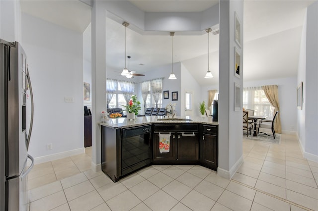 kitchen featuring light stone counters, ceiling fan, sink, black dishwasher, and stainless steel refrigerator