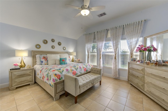 bedroom featuring ceiling fan, light tile patterned flooring, and vaulted ceiling