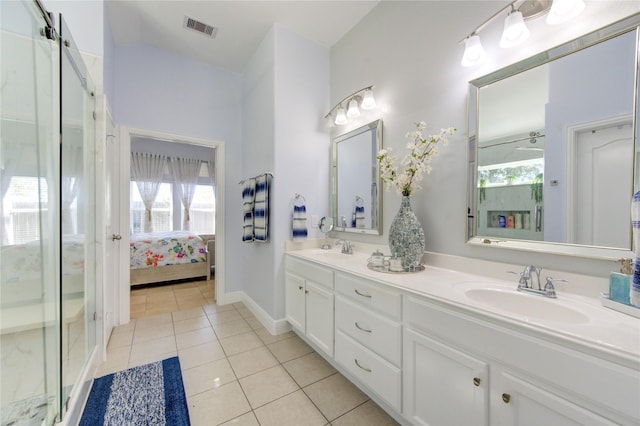 bathroom with tile patterned floors, vanity, and an enclosed shower