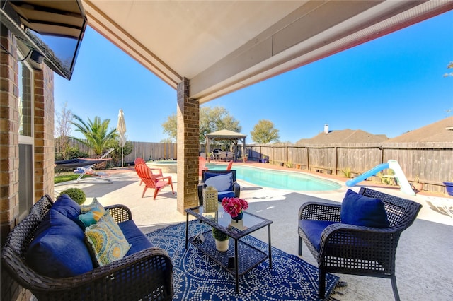 view of patio featuring a fenced in pool and a gazebo