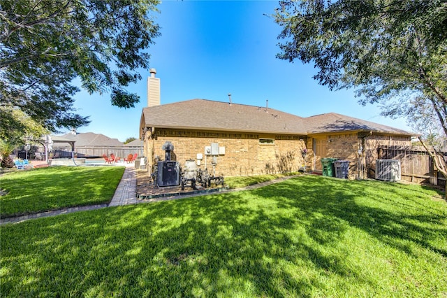 rear view of property with a yard and cooling unit