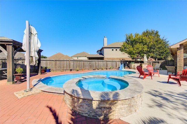 view of swimming pool with an in ground hot tub and a deck