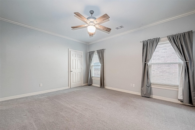 carpeted empty room with ceiling fan and crown molding