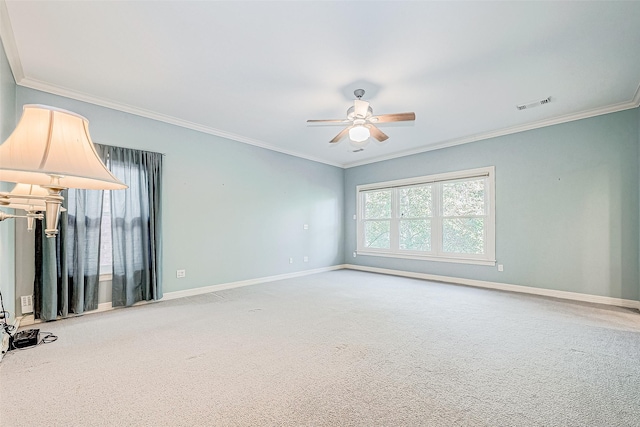 carpeted spare room featuring ceiling fan and crown molding