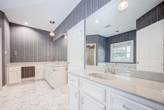 bathroom featuring vanity and an enclosed shower