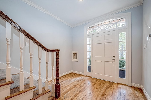 entrance foyer with light wood-type flooring and ornamental molding