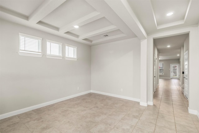 spare room featuring beamed ceiling, light tile patterned flooring, and coffered ceiling