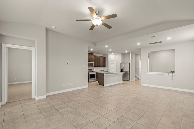 unfurnished living room featuring ceiling fan and light tile patterned floors