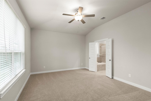 carpeted empty room featuring ceiling fan and lofted ceiling