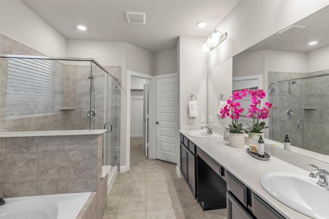 bathroom with tile patterned flooring, vanity, and shower with separate bathtub