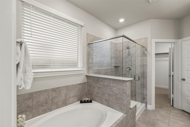 bathroom featuring tile patterned flooring, plenty of natural light, and independent shower and bath