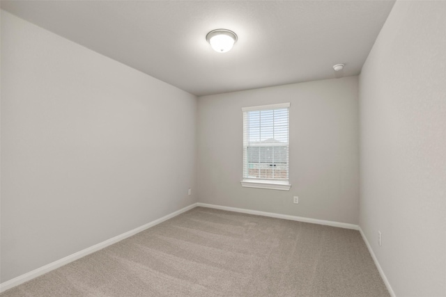 unfurnished room with light colored carpet