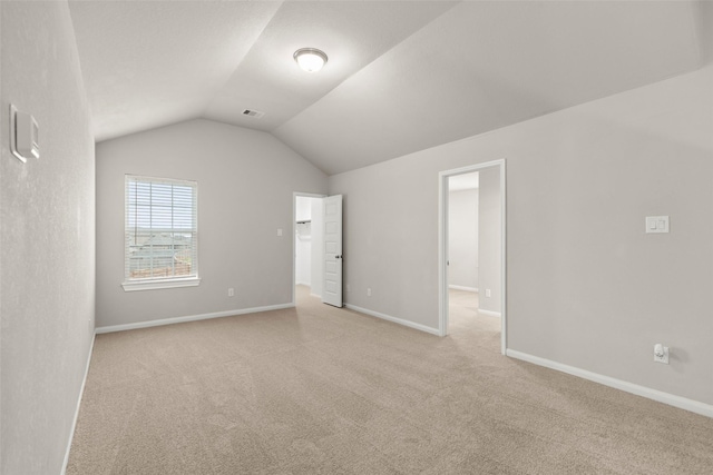 interior space featuring light carpet and lofted ceiling