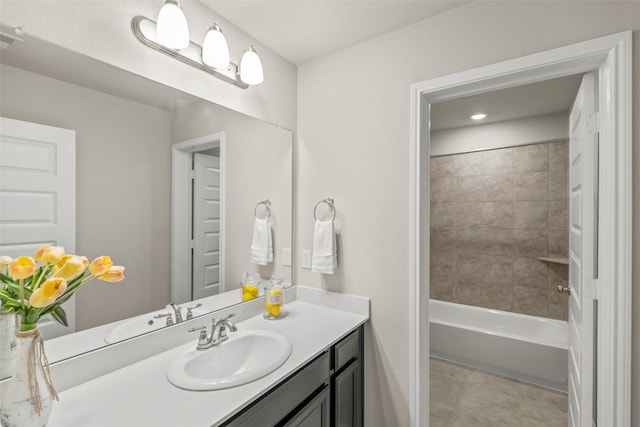 bathroom with vanity and tiled shower / bath combo