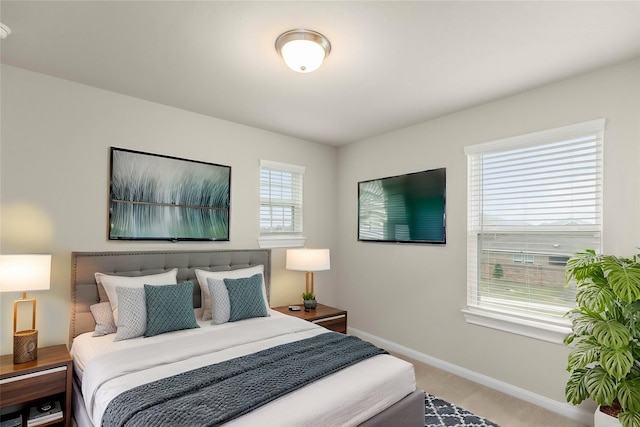 bedroom with carpet flooring and multiple windows