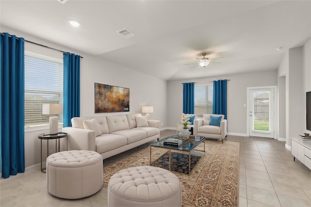 tiled living room with ceiling fan and vaulted ceiling