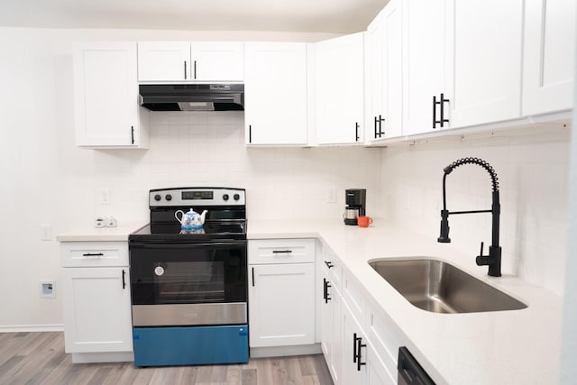 kitchen with white cabinets, electric range, and sink