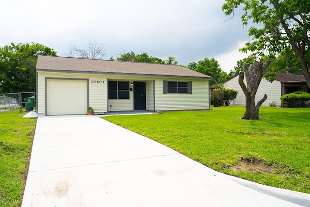 ranch-style house featuring a garage and a front lawn