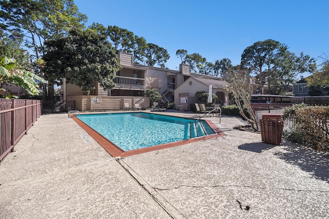 view of swimming pool with a patio area