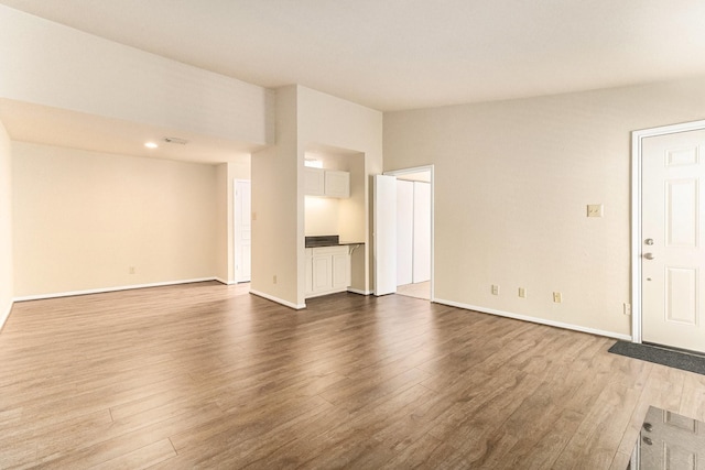 unfurnished living room featuring wood-type flooring