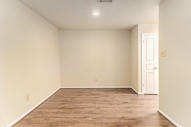 spare room featuring light hardwood / wood-style floors