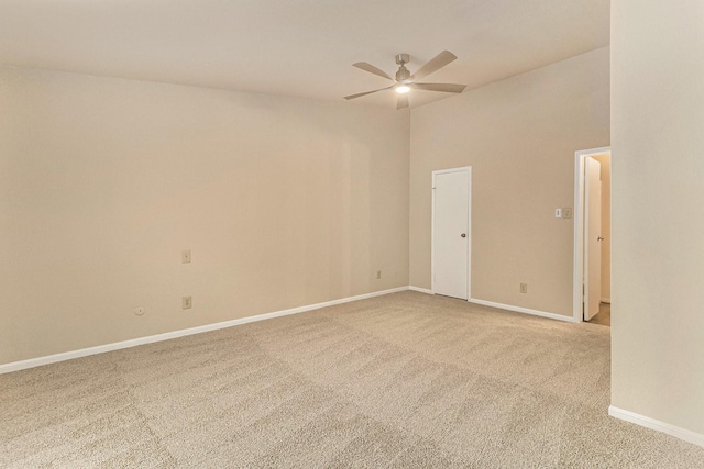 empty room with carpet flooring, ceiling fan, and a towering ceiling