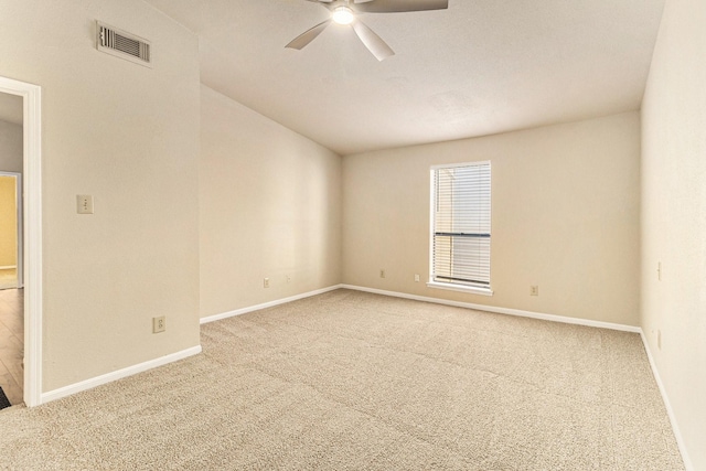 spare room with ceiling fan and carpet floors