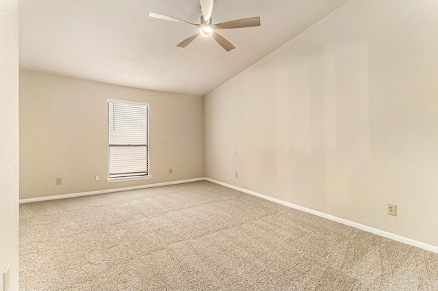 carpeted spare room featuring vaulted ceiling and ceiling fan