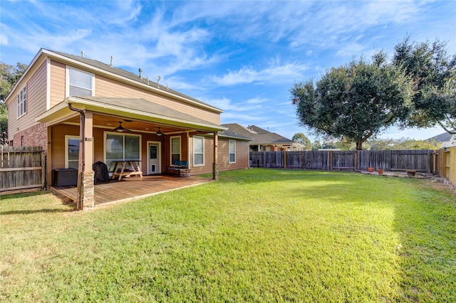 rear view of property with a lawn and a wooden deck