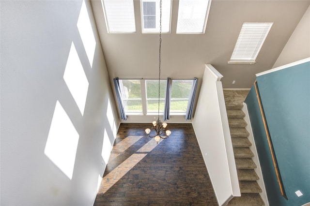 interior space featuring a high ceiling and an inviting chandelier