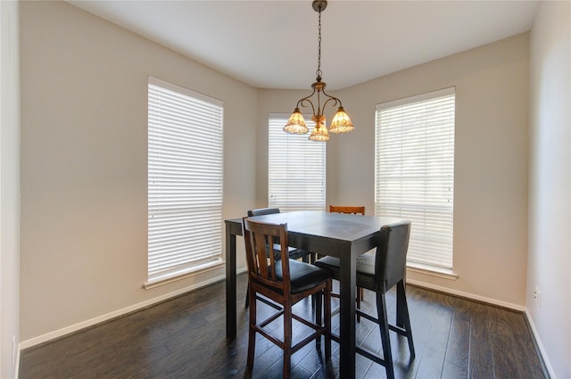 dining space featuring plenty of natural light, dark hardwood / wood-style flooring, and a chandelier