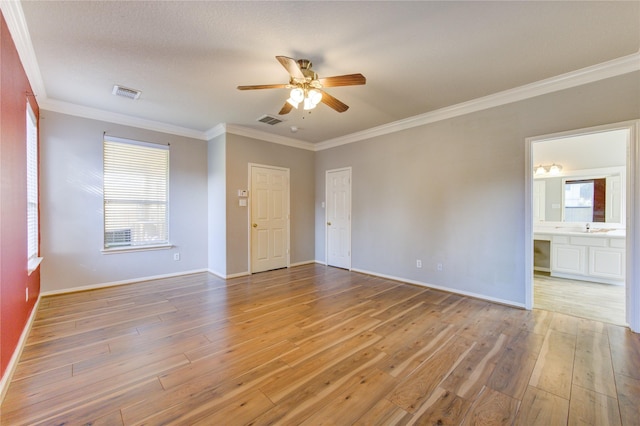 spare room with ceiling fan, light hardwood / wood-style flooring, a healthy amount of sunlight, and ornamental molding