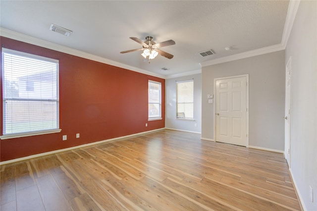 empty room with light wood-type flooring, ceiling fan, and ornamental molding