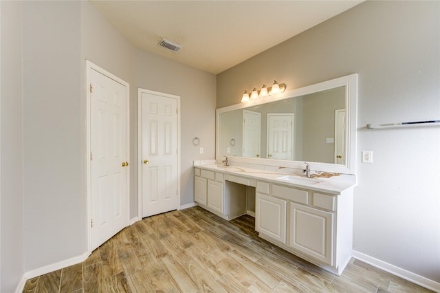 bathroom with wood-type flooring and vanity