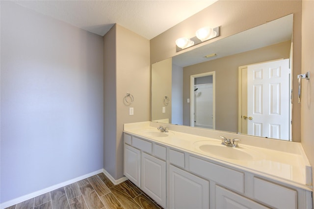 bathroom featuring vanity and a textured ceiling