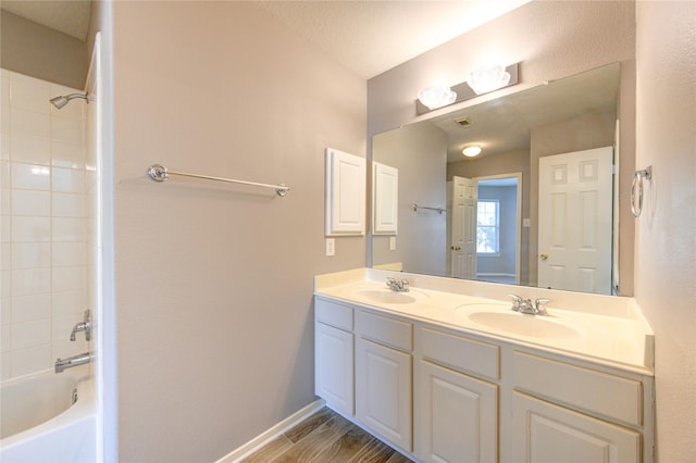 bathroom featuring shower / bathing tub combination, vanity, a textured ceiling, and hardwood / wood-style floors