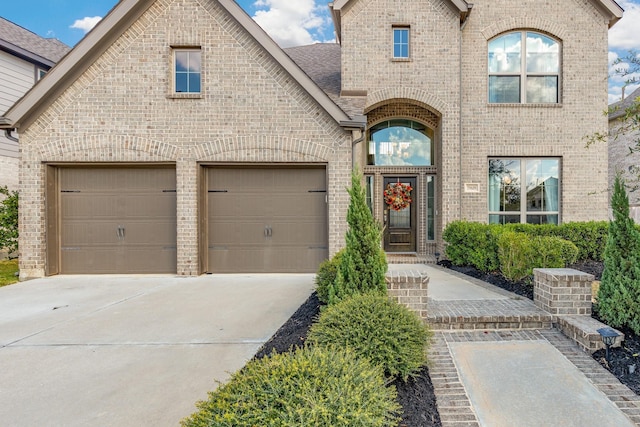 french country style house featuring a garage