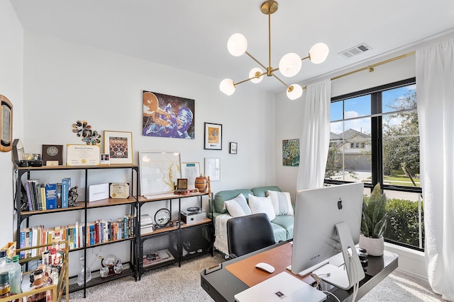 office space featuring carpet flooring, a healthy amount of sunlight, and an inviting chandelier